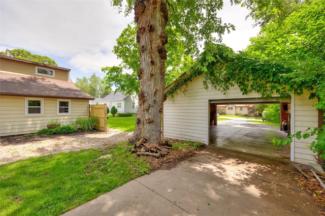 1144 57th St, Des Moines, IA 50311 - view of grassy yard featuring driveway and a garage