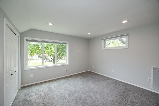 1144 57th St, Des Moines, IA 50311 - unfurnished bedroom with carpet flooring, vaulted ceiling, recessed lighting, and a closet