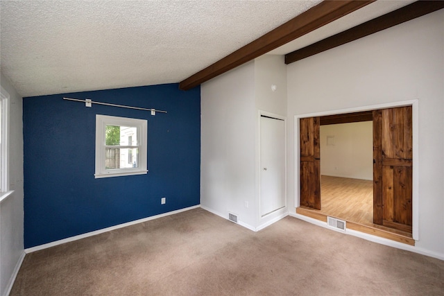 1144 57th St, Des Moines, IA 50311 - unfurnished bedroom featuring carpet floors, a textured ceiling, and a closet