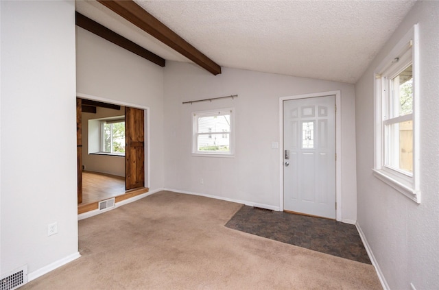 1144 57th St, Des Moines, IA 50311 - carpeted entryway featuring baseboards and a textured ceiling
