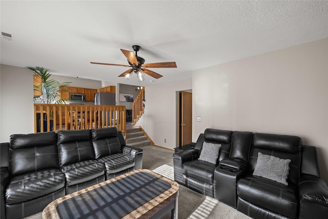 1215 7th Ave SE, Altoona, IA 50009 - living area featuring carpet, a ceiling fan, and stairway