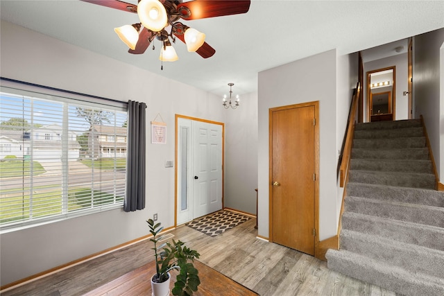 1215 7th Ave SE, Altoona, IA 50009 - entrance foyer with light wood-style floors, stairway, ceiling fan, and a chandelier