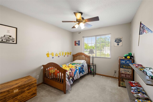 1215 7th Ave SE, Altoona, IA 50009 - carpeted bedroom featuring baseboards and a ceiling fan