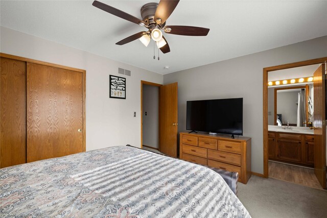 1215 7th Ave SE, Altoona, IA 50009 - bedroom with light carpet, a closet, connected bathroom, and a ceiling fan