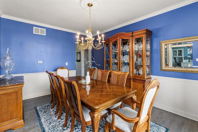 15222 Wilden Dr, Urbandale, IA 50323 - dining room with dark wood-type flooring, a chandelier, and crown molding