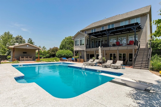 15222 Wilden Dr, Urbandale, IA 50323 - swimming pool featuring stairway, a patio area, and a diving board