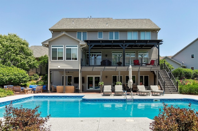 15222 Wilden Dr, Urbandale, IA 50323 - back of property featuring outdoor lounge area, stairs, an outdoor pool, and a patio area