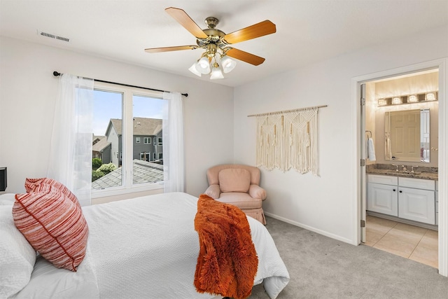 15222 Wilden Dr, Urbandale, IA 50323 - bedroom featuring light colored carpet, ensuite bathroom, and a ceiling fan