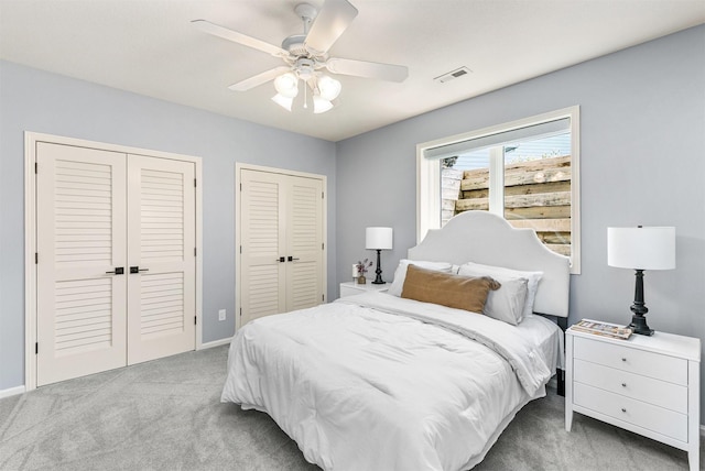 15222 Wilden Dr, Urbandale, IA 50323 - bedroom featuring carpet, multiple closets, and ceiling fan