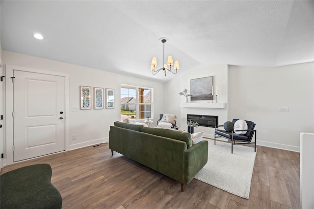 305 S Valley View Dr, Norwalk, IA 50211 - living area featuring a chandelier, lofted ceiling, wood finished floors, a glass covered fireplace, and recessed lighting