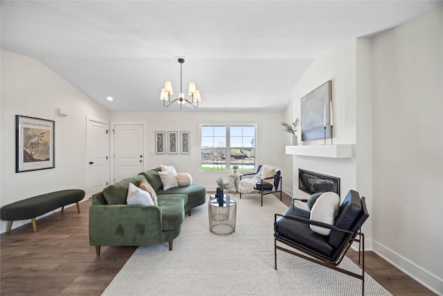 305 S Valley View Dr, Norwalk, IA 50211 - living room featuring a chandelier, wood finished floors, lofted ceiling, a glass covered fireplace, and recessed lighting