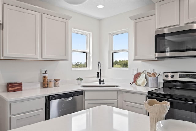 305 S Valley View Dr, Norwalk, IA 50211 - kitchen with appliances with stainless steel finishes, light countertops, white cabinetry, and recessed lighting