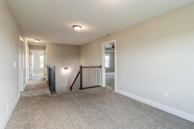 1720 SE Waddell Way, Waukee, IA 50263 - empty room featuring carpet flooring and healthy amount of natural light