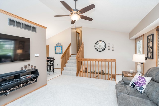 530 N 9th St, Carlisle, IA 50047 - living room featuring a ceiling fan, carpet floors, vaulted ceiling, and stairway