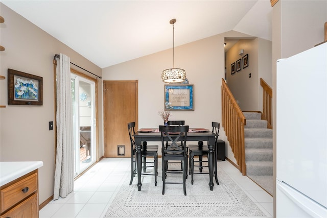 530 N 9th St, Carlisle, IA 50047 - dining room featuring light tile patterned floors, lofted ceiling, stairway, and a chandelier