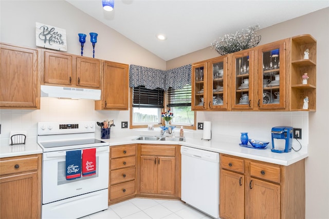 530 N 9th St, Carlisle, IA 50047 - kitchen with white appliances, under cabinet range hood, vaulted ceiling, backsplash, and light countertops