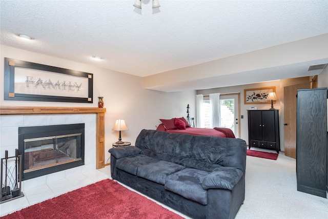530 N 9th St, Carlisle, IA 50047 - living area with a textured ceiling, a fireplace, and carpet flooring