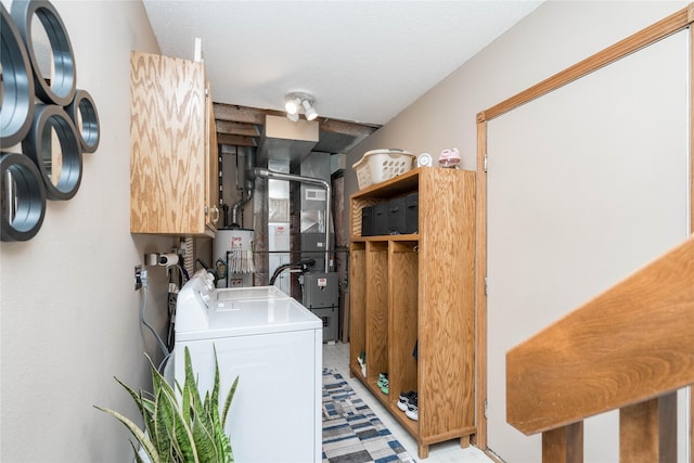 530 N 9th St, Carlisle, IA 50047 - laundry room with gas water heater, separate washer and dryer, heating unit, light flooring, and cabinet space