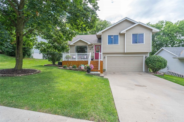 530 N 9th St, Carlisle, IA 50047 - split level home with a garage, a porch, driveway, and a front yard