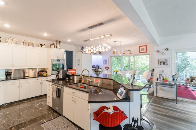 4709 Colt Dr, West Des Moines, IA 50265 - kitchen featuring appliances with stainless steel finishes, open shelves, recessed lighting, a center island with sink, and white cabinetry