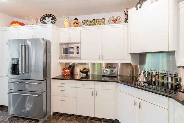 4709 Colt Dr, West Des Moines, IA 50265 - kitchen with stainless steel appliances, dark marble finish floors, white cabinets, and backsplash