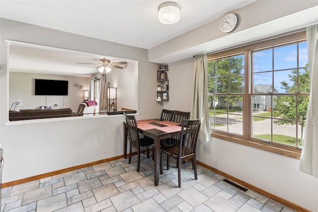 206 Main St, Grinnell, IA 50112 - dining space with ceiling fan and stone finish flooring