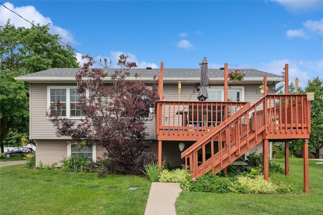 206 Main St, Grinnell, IA 50112 - back of house featuring a lawn, a wooden deck, stairs, and roof with shingles