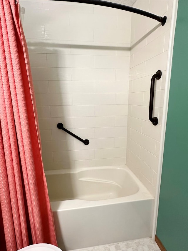 206 Main St, Grinnell, IA 50112 - bathroom featuring shower / bathtub combination with curtain and toilet