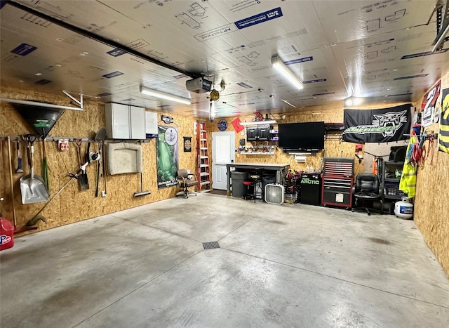 206 Main St, Grinnell, IA 50112 - garage with a workshop area and a garage door opener