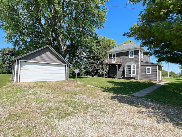 6285 E 28th St N, Newton, IA 50208 - view of green lawn featuring a garage, a deck, and an outdoor structure