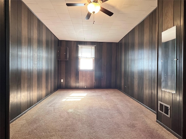 6285 E 28th St N, Newton, IA 50208 - unfurnished room featuring light carpet, ceiling fan, and wooden walls