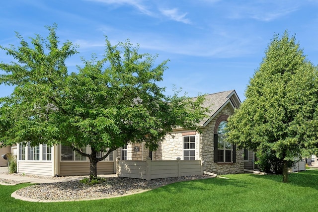 3305 SE Glenstone Dr Unit 172, Grimes, IA 50111 - view of front of home featuring stone siding and a front yard