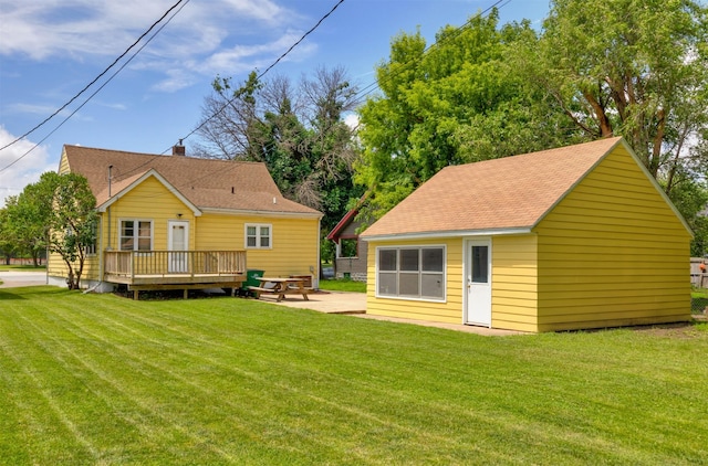 221 9th St, West Des Moines, IA 50265 - rear view of house with a deck, an outdoor structure, a lawn, and a shingled roof