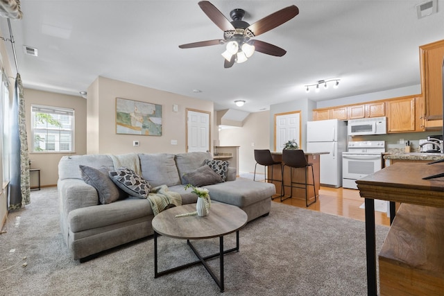 8302 Westown Pkwy Unit 8110, West Des Moines, IA 50266 - living room with a ceiling fan and light colored carpet