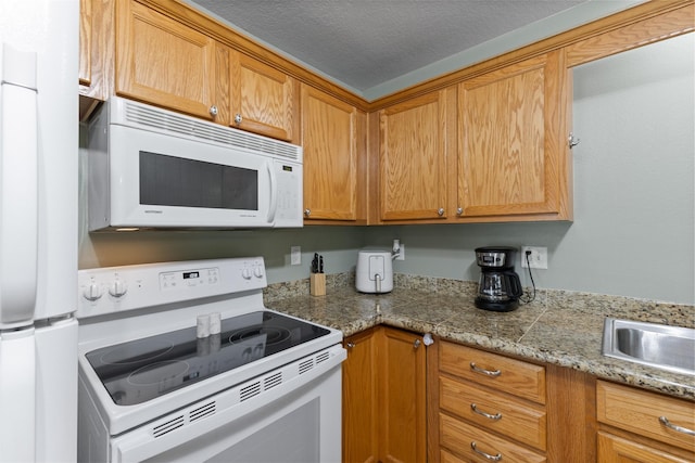 8302 Westown Pkwy Unit 8110, West Des Moines, IA 50266 - kitchen featuring white appliances, brown cabinets, and light countertops
