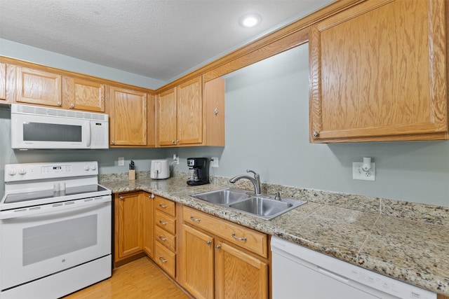8302 Westown Pkwy Unit 8110, West Des Moines, IA 50266 - kitchen featuring white appliances, light wood-style floors, a textured ceiling, and recessed lighting
