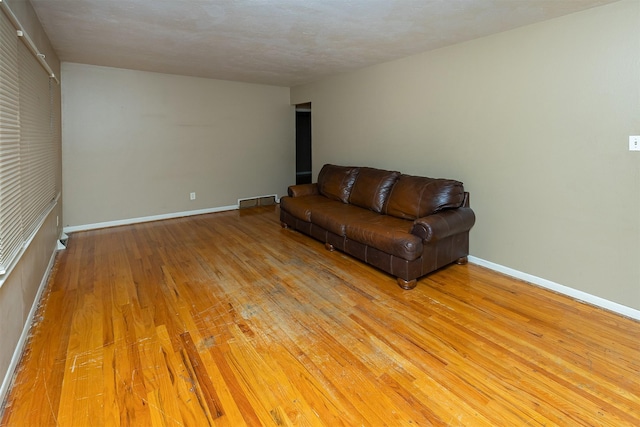 832 E Lacona Ave, Des Moines, IA 50315 - unfurnished living room with light wood-style floors and baseboards