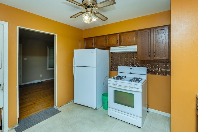 832 E Lacona Ave, Des Moines, IA 50315 - kitchen with white appliances, under cabinet range hood, and ceiling fan
