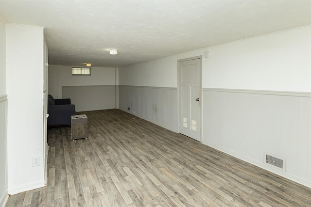 832 E Lacona Ave, Des Moines, IA 50315 - unfurnished room with light wood-type flooring and wainscoting