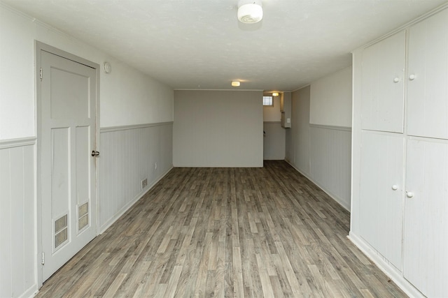 832 E Lacona Ave, Des Moines, IA 50315 - spare room featuring light wood finished floors and wainscoting