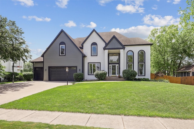 14638 Woodcrest Dr, Clive, IA 50325 - french country style house with an attached garage, concrete driveway, and roof with shingles