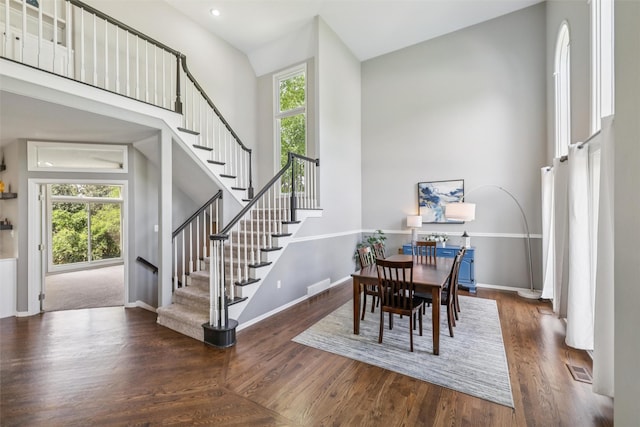 14638 Woodcrest Dr, Clive, IA 50325 - dining space featuring a high ceiling, stairway, and wood finished floors