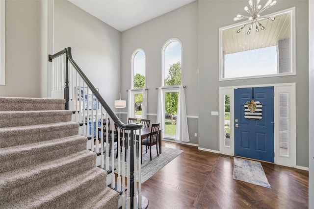 14638 Woodcrest Dr, Clive, IA 50325 - foyer entrance with a towering ceiling, a chandelier, stairway, and wood finished floors
