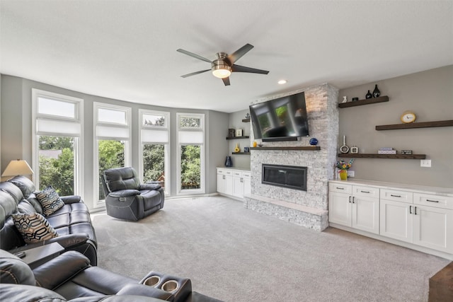 14638 Woodcrest Dr, Clive, IA 50325 - living room featuring healthy amount of natural light, a ceiling fan, light carpet, a stone fireplace, and recessed lighting