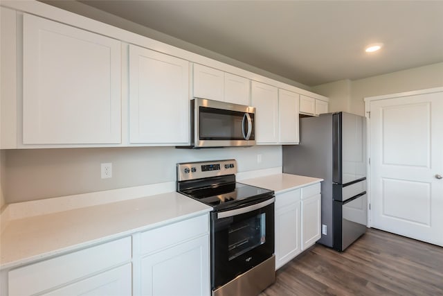 4404 NE 16th St, Ankeny, IA 50021 - kitchen featuring stainless steel appliances, light countertops, white cabinetry, dark wood-type flooring, and recessed lighting