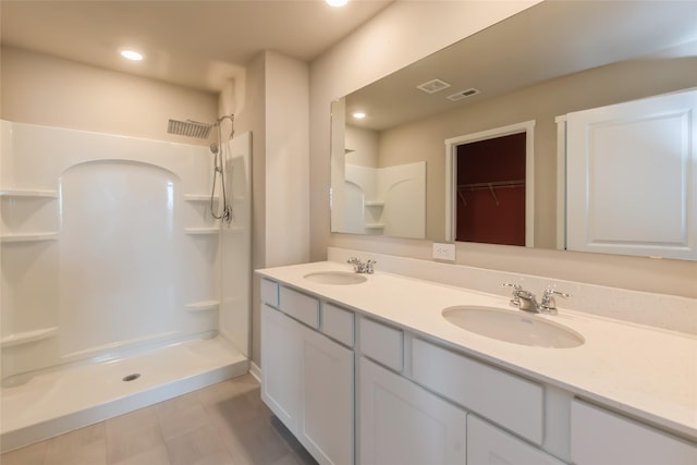 4404 NE 16th St, Ankeny, IA 50021 - full bathroom featuring a walk in shower, double vanity, tile patterned flooring, a spacious closet, and recessed lighting