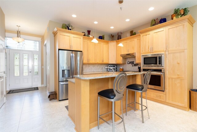 862 Glen Oaks Ter, West Des Moines, IA 50266 - kitchen with stainless steel appliances, light brown cabinets, under cabinet range hood, decorative backsplash, and light stone counters