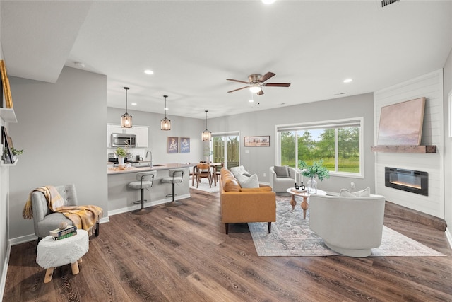 832 Kinney Cir NE, Bondurant, IA 50035 - living area featuring recessed lighting, a large fireplace, dark wood-style floors, and a ceiling fan