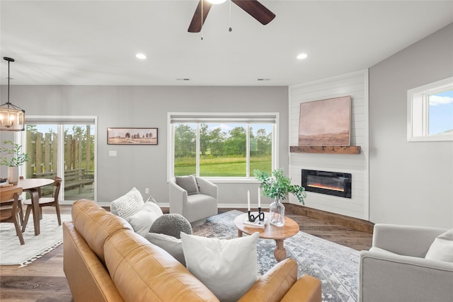832 Kinney Cir NE, Bondurant, IA 50035 - living area featuring wood finished floors, a chandelier, a fireplace, a ceiling fan, and recessed lighting