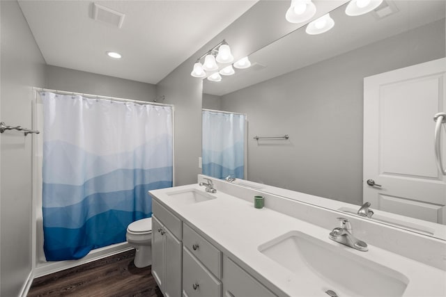832 Kinney Cir NE, Bondurant, IA 50035 - bathroom with wood finished floors, double vanity, shower / bath combo, and recessed lighting
